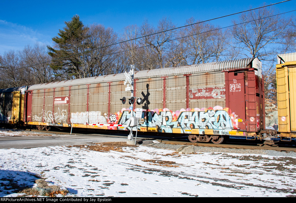 An autorack still in Conrail paint rolls over Snake Hill Road